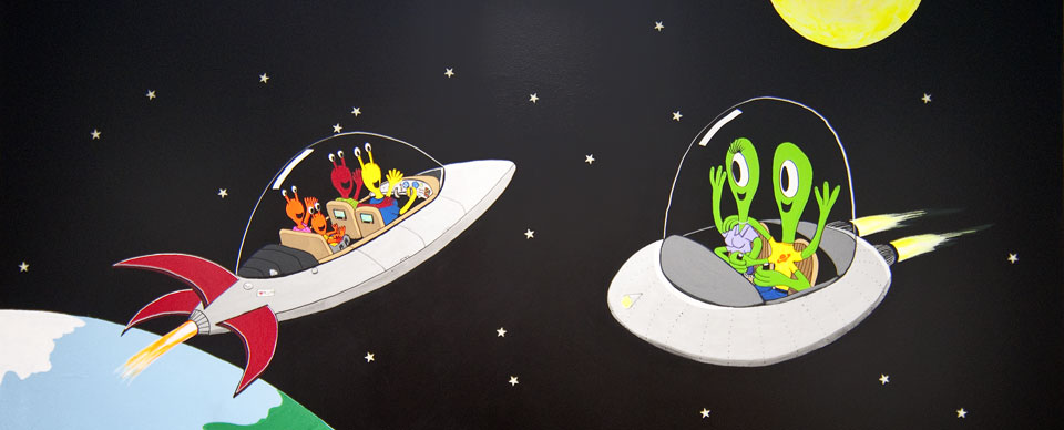 A photo of a mural inside one of Athens Neurological pediatric exam rooms showing two UFOs with passing in space.